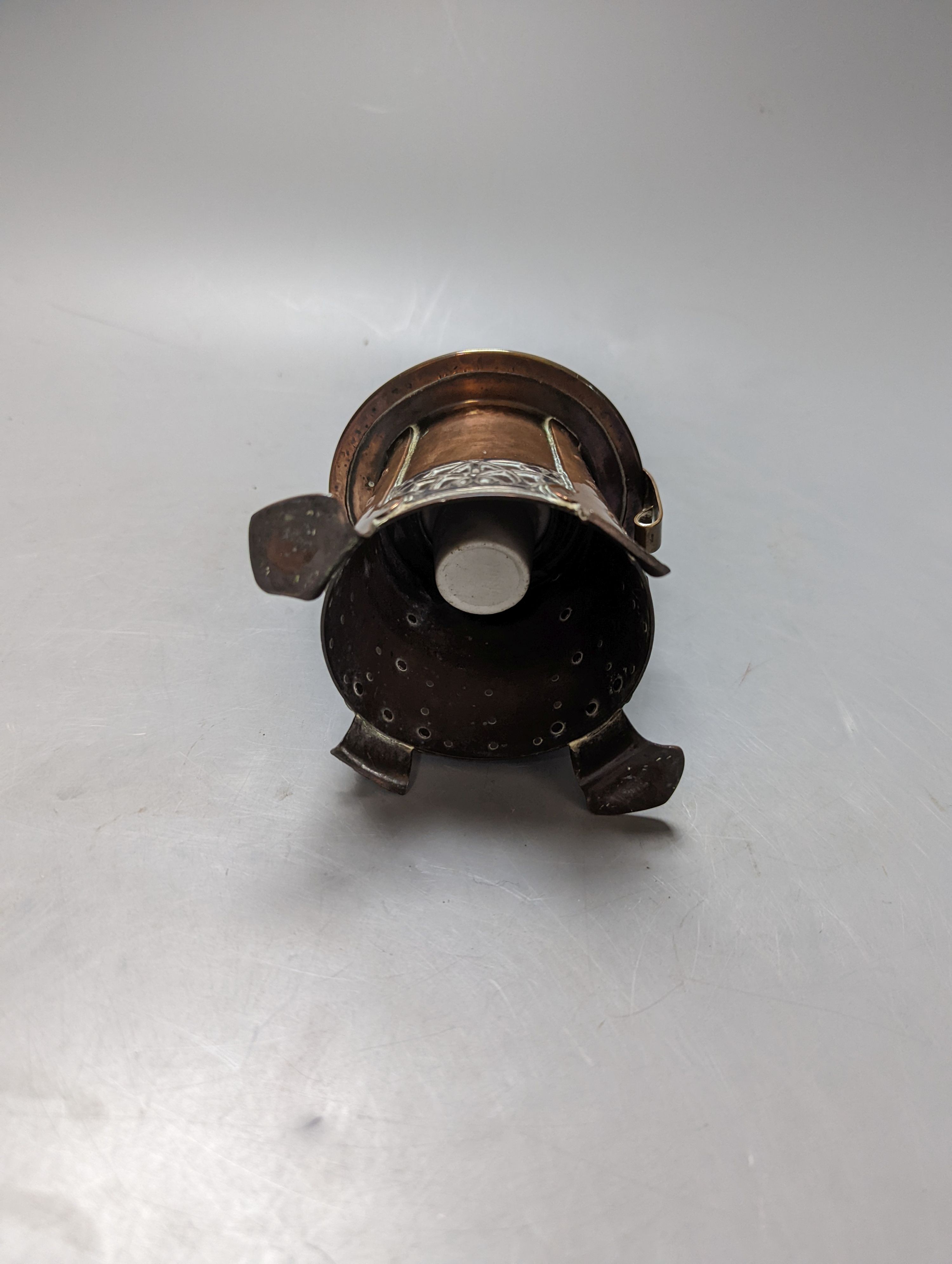 An Arts and Crafts copper and white metal inkwell, unsigned, 9 cms high.